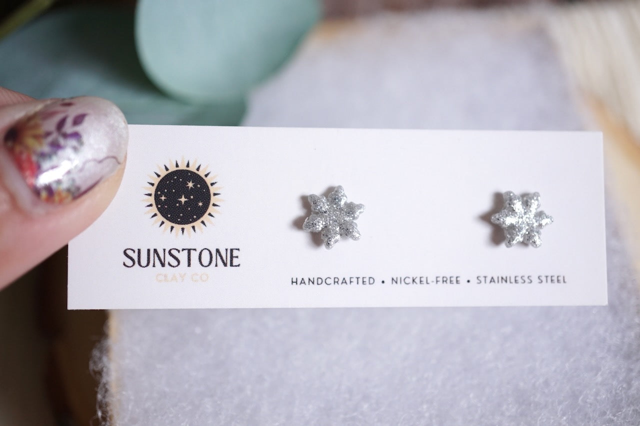 Handcrafted glittery snowflake stud earrings in silver