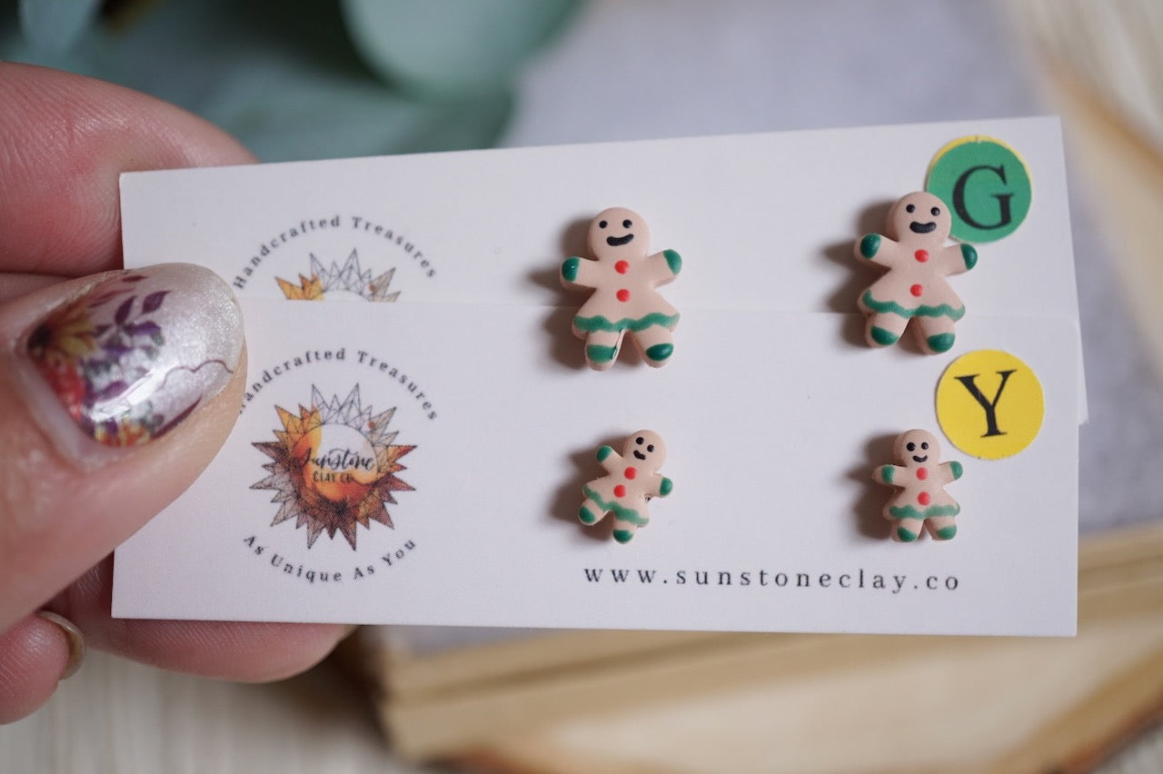 Handcrafted gingerbread women stud earrings with icing details on nickel-free stainless steel posts in small and large sizes.