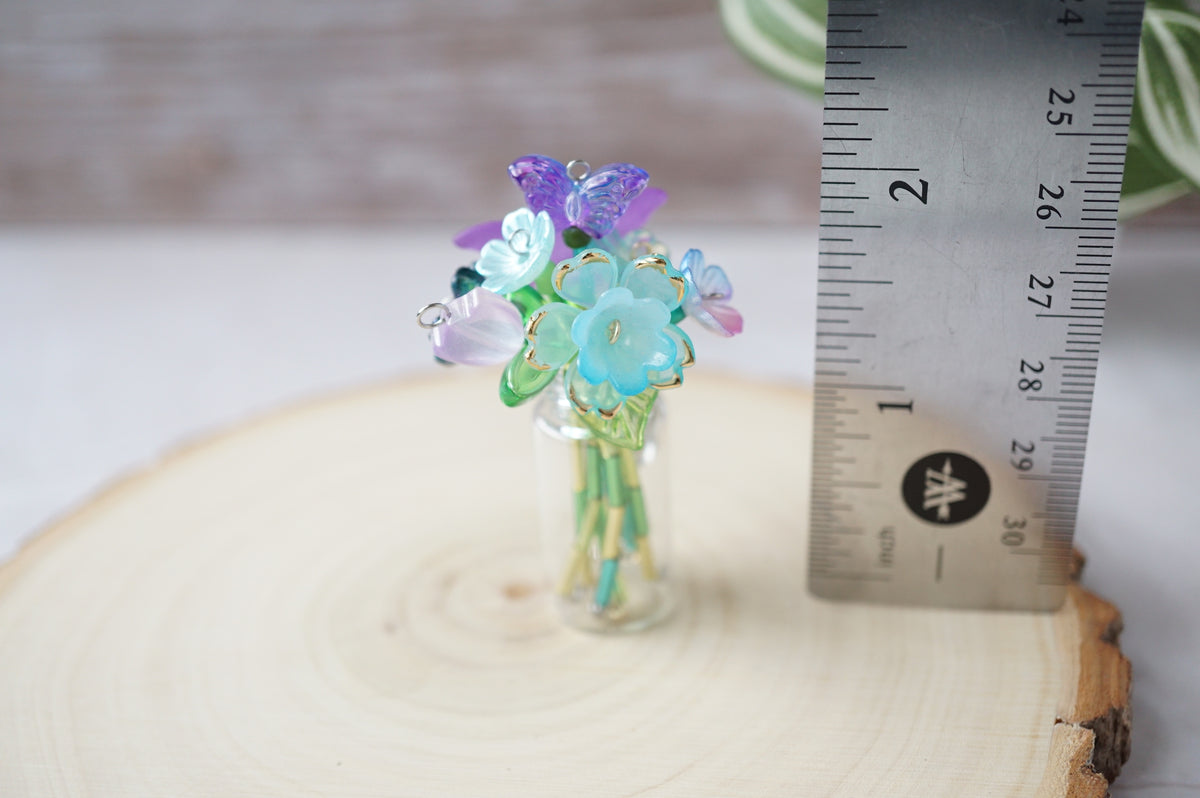 Forever flowers assembled in a vase, standing alongside a ruler showing a height a little under 2 inches