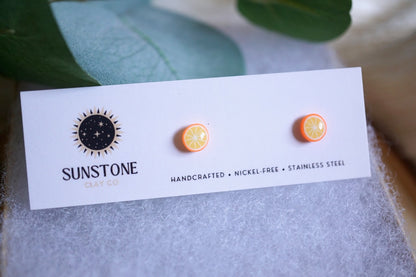 Handcrafted tiny orange slice stud earrings by Sunstone Clay Co