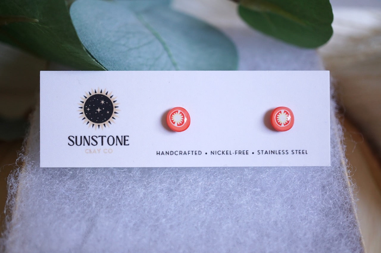 Handcrafted tomato slice stud earrings on Sunstone Clay Co display card