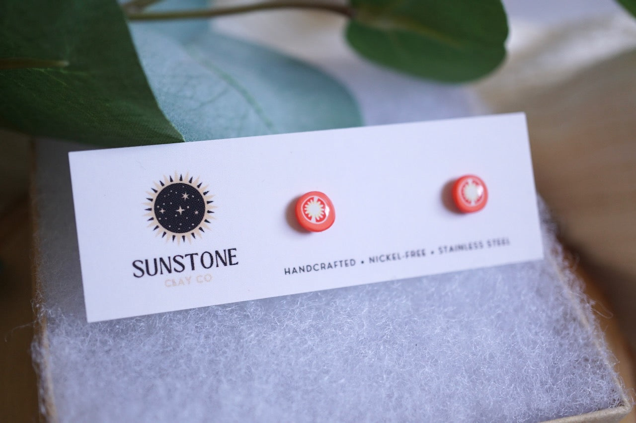 Handcrafted tomato slice stud earrings on Sunstone Clay Co display card