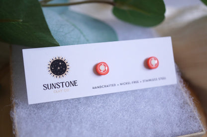 Handcrafted tomato slice stud earrings on Sunstone Clay Co display card