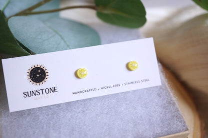 Handcrafted lemon slice stud earrings on Sunstone Clay Co. card
