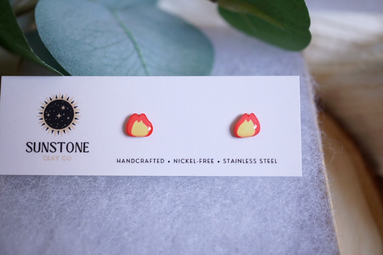 Small polymer clay flame earrings with yellow center and red-orange outline
