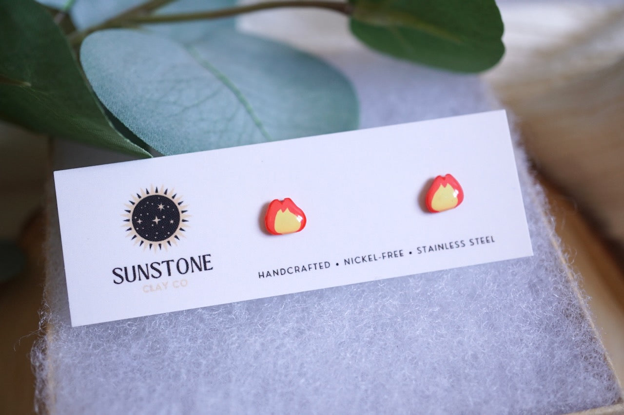 Small polymer clay flame earrings with yellow center and red-orange outline