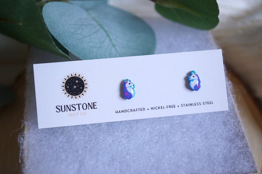 Earring card with 'Sunstone' branding and two colorful unicorn earrings on an earring card.