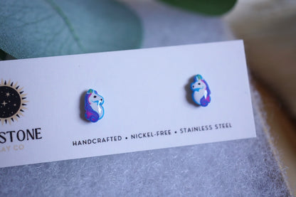 Earring card with 'Sunstone' branding and two colorful unicorn earrings on an earring card.