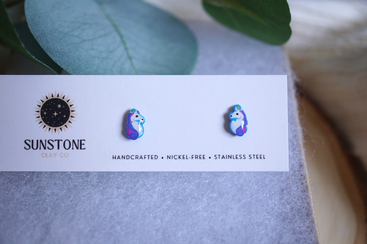 Earring card with 'Sunstone' branding and two colorful unicorn earrings on an earring card.