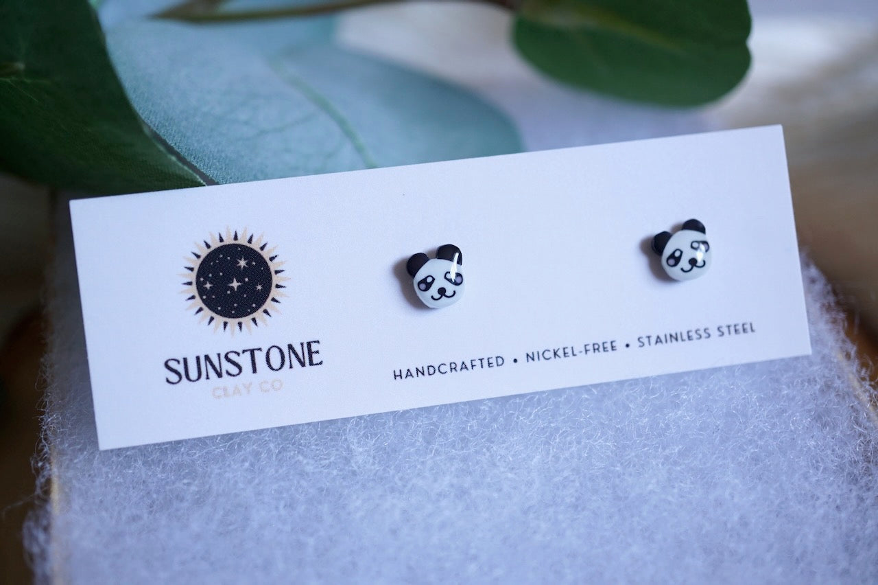 Small black-and-white panda earrings made from polymer clay