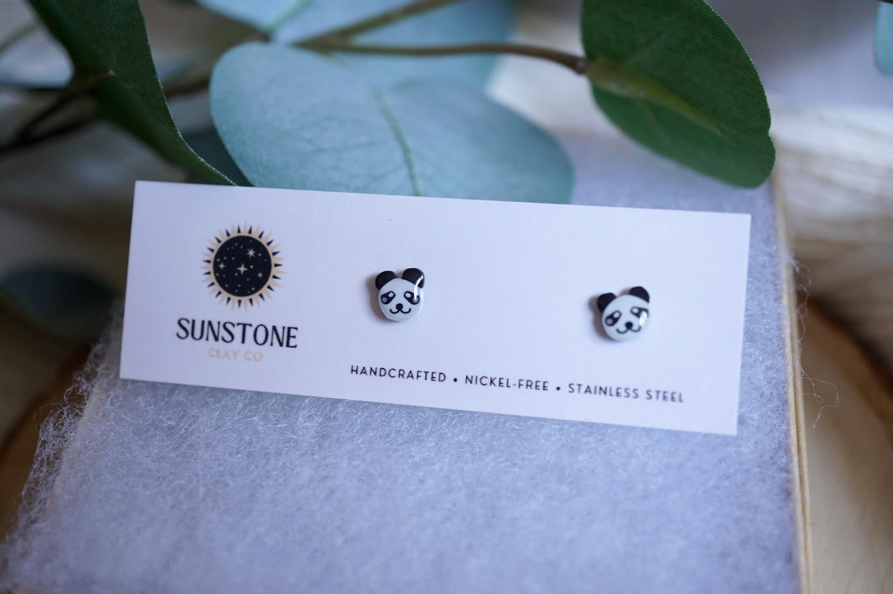 Small black-and-white panda earrings made from polymer clay