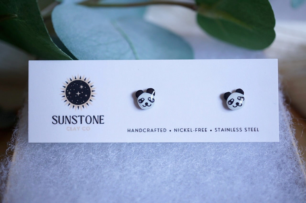 Small black-and-white panda earrings made from polymer clay