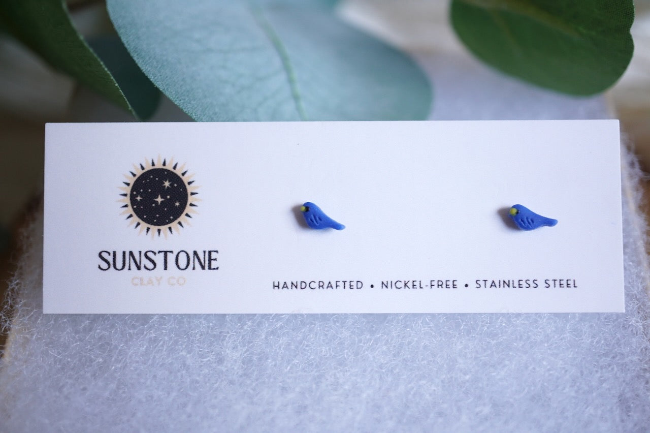 Miniature blue bird polymer clay studs on jewelry display card