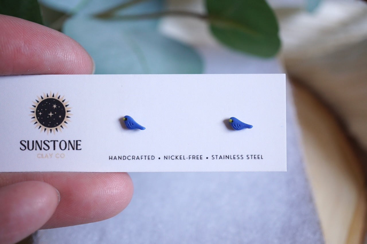 Miniature blue bird polymer clay studs on jewelry display card