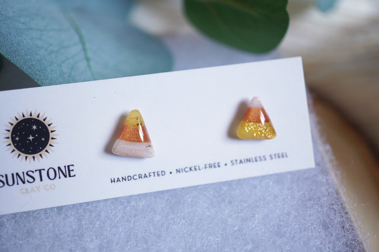 Polymer clay candy corn earrings with translucent amber and white gradient