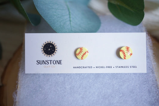 Softball stud earrings on a branded Sunstone Clay Co display card
