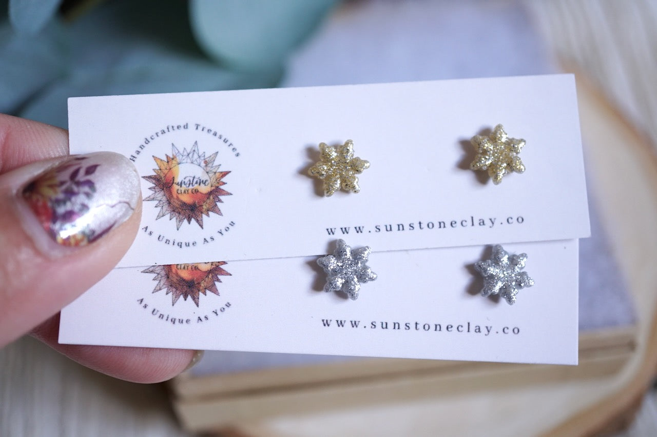 Handcrafted glittery snowflake stud earrings in gold and silver