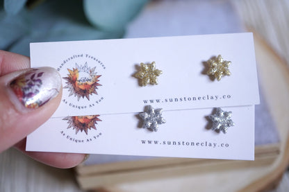 Handcrafted glittery snowflake stud earrings in gold and silver