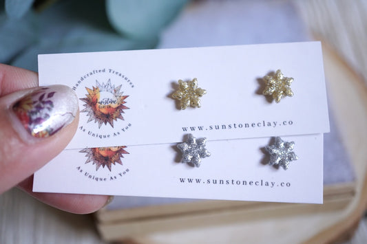 Handcrafted glittery snowflake stud earrings in gold and silver
