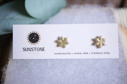 Handcrafted glittery snowflake stud earrings in gold