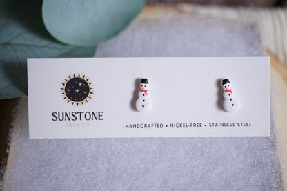 Handcrafted snowman stud earrings with black hats and red scarves
