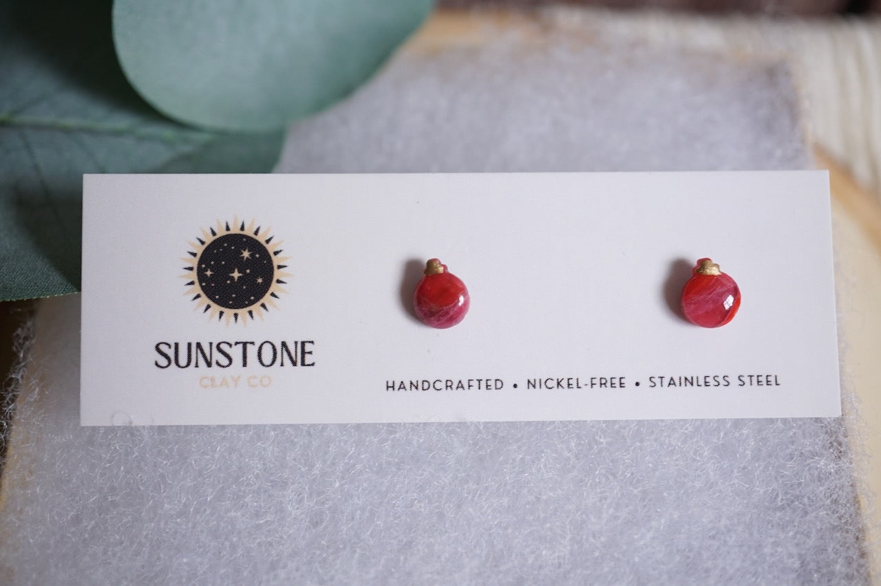 Small handcrafted ornament earrings in red options.