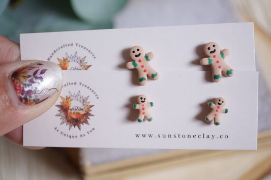 Handcrafted gingerbread men stud earrings with icing details on nickel-free stainless steel posts in small and large sizes.