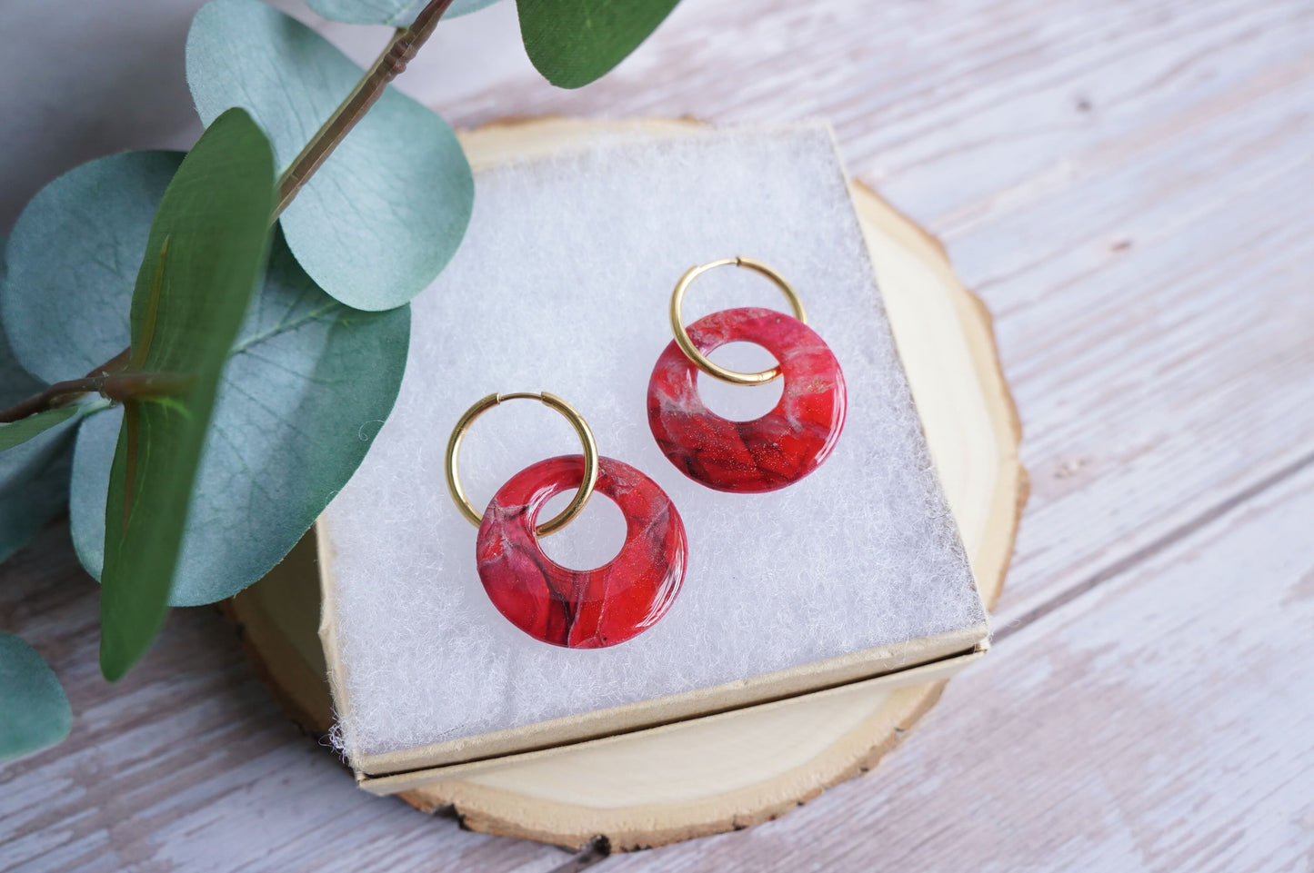 Handmade circle crimson earrings with marbled stone effect on gold hoops