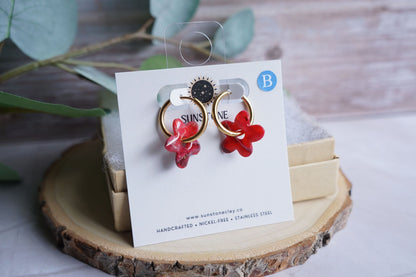 Handmade crimson flower earrings with marbled stone effect
