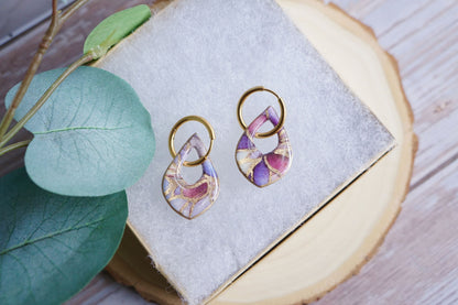 Lightweight blush statement earrings on neutral display