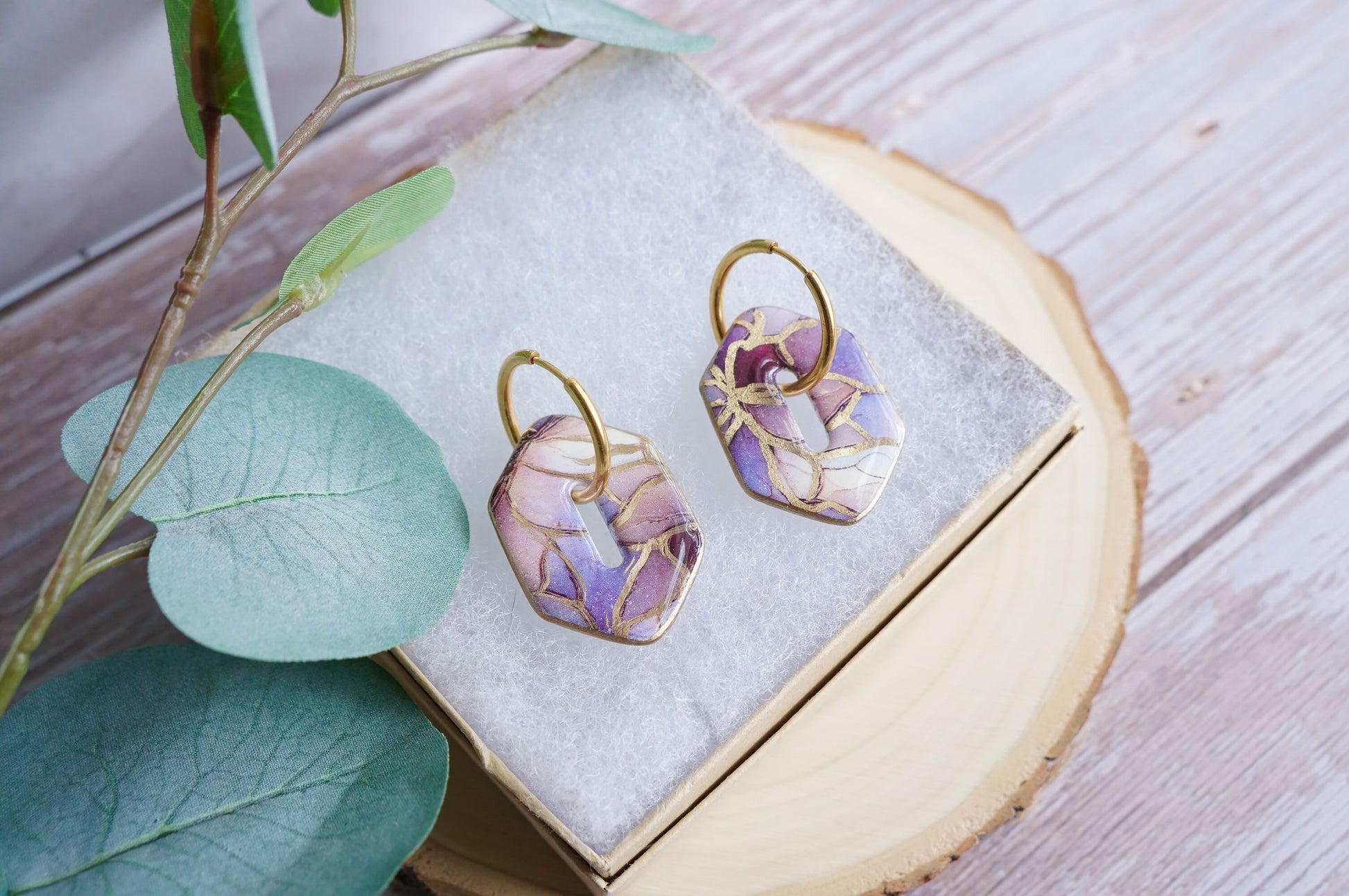 Lightweight blush statement earrings on neutral display