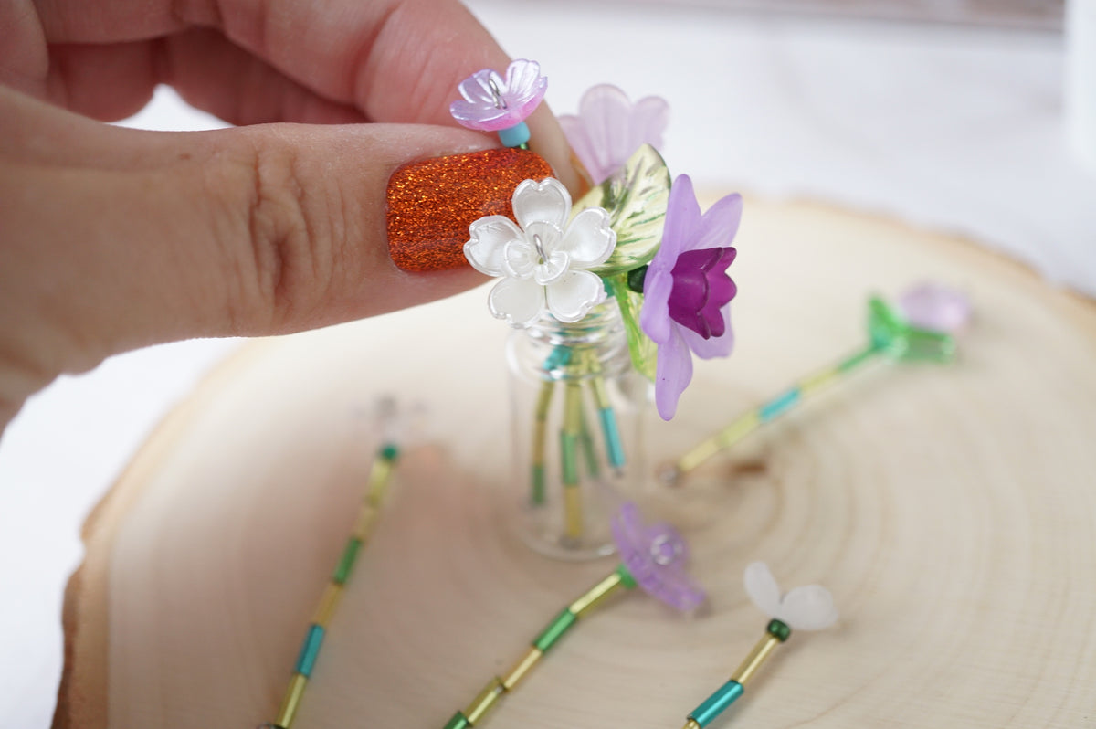Forever flowers being placed individually in the vase