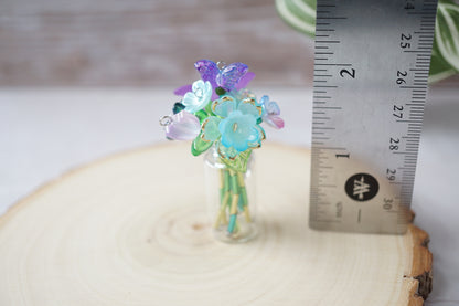 Forever flowers assembled in a vase, standing alongside a ruler showing a height a little under 2 inches
